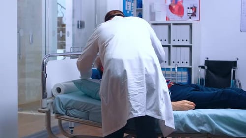 Doctor Attends Senior Patient in Hospital Room