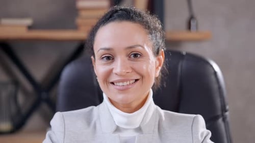 Smiling Woman Wearing Professional Attire in Office