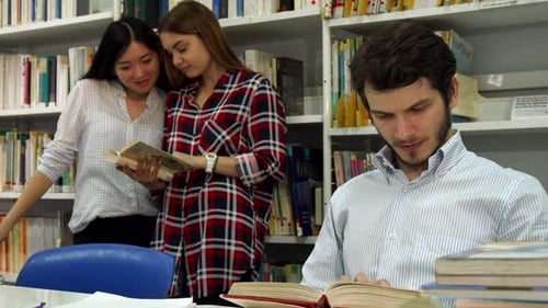 Male Students Reads the Book at the Library