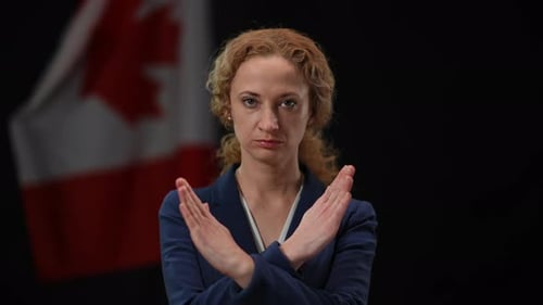 Serious Woman Crossing Hands in No Gesture Looking at Camera