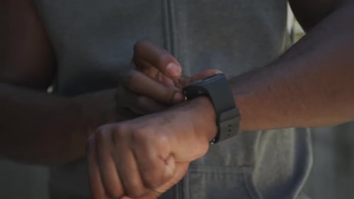 Man Interacts With Smart Watch During Daytime