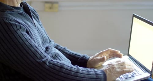 Man relaxing on sofa using laptop