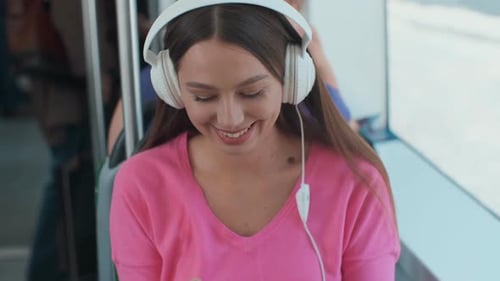 Woman Listening to Music on Public Transportation
