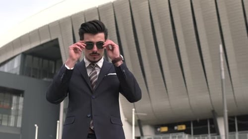 Stylish Young Adult Poses with Sunglasses