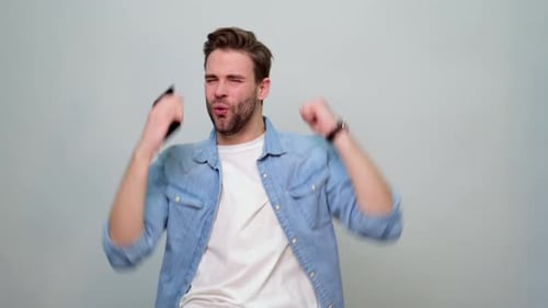 Excited Man Playing Mobile Game App on Phone