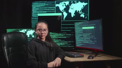 Asian Young Girl Hacker Hacking With Multiple Computer Screens And Pose In Dark Room