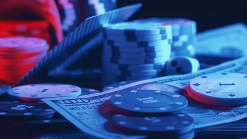 Casino Chips and Playing Cards with Money in Motion
