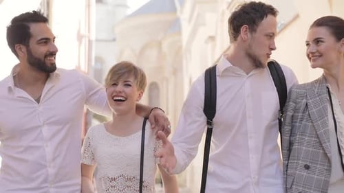 Happy Young People Walking Along City Street