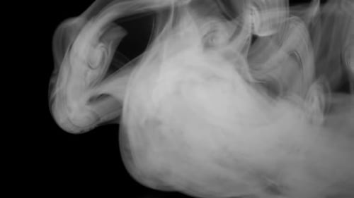 Gray Smoke Billowing Abstractly on Black Background
