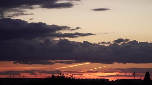 Colorful Sunset Sky Over Distant City Silhouette