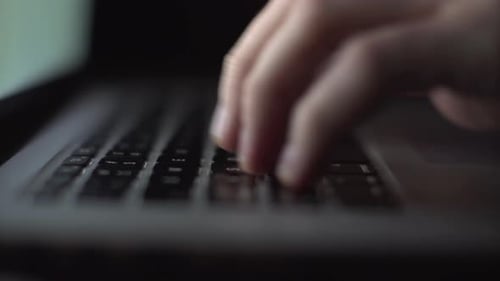 Extreme Closeup Hands of Unrecognizable Hacker Programmer Working Typing on Keyboard Laptop Computer