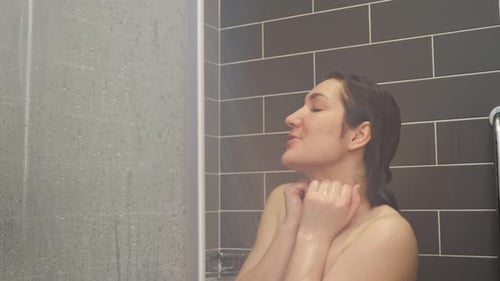 Woman Enjoys Relaxing Shower in Modern Bathroom