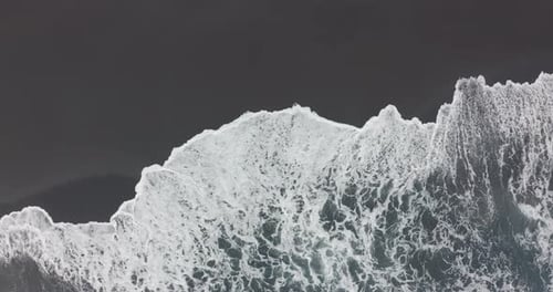 Aerial View. Black Sand Beach, Beautiful Ocean Waves Crashing on Coastline, Natural Volcanic Beach