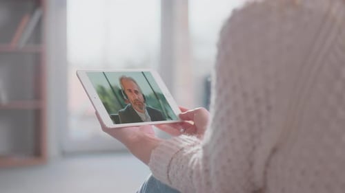 Woman Has Video Call with Man on Tablet
