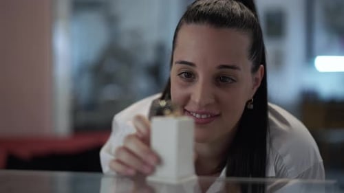 Woman Smiling at Jewelry in a Box