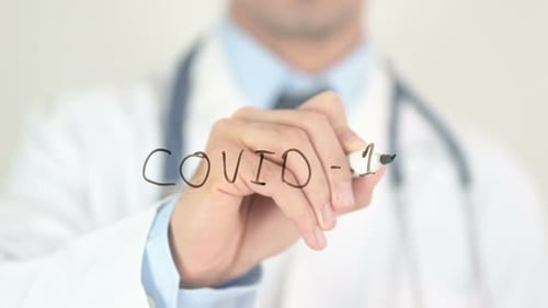 Doctor Writes COVID-19 Message with Marker