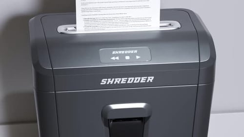 Shredding important documents. Following view at a page being shredded. 4KHD