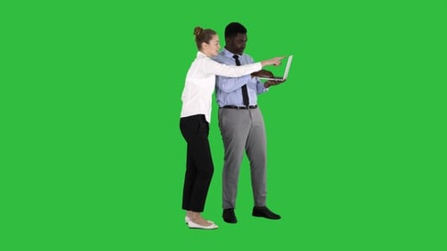 Colleagues Reviewing Laptop on Green Screen Background