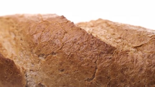 Extreme Close Up Macro Footage of Beautiful Loaf of White Bread Ready for Breakfast on White