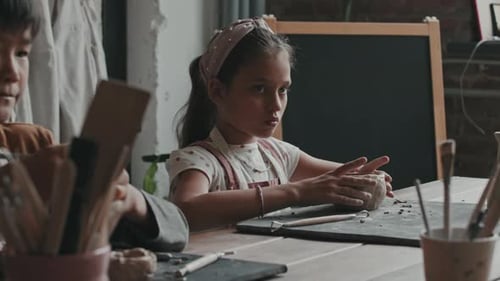 Girl Shaping Clay Bowl in Pottery Studio