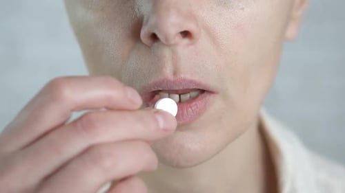 Adult Woman Taking Pill, Extreme Close Up