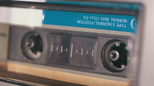 Audio Cassette Is Inserted Into the Deck of the Audio Tape Recorder Playing and Rotates
