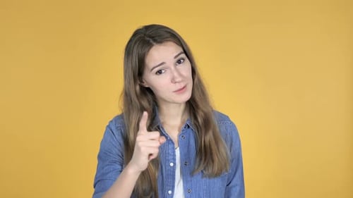 Woman Gesturing and Communicating Against Yellow Background