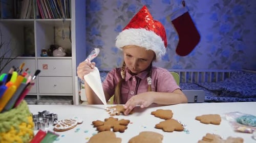 Girl Decorating Christmas Cookies at Home