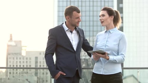 Business People Discussing Work on Tablet Outdoors