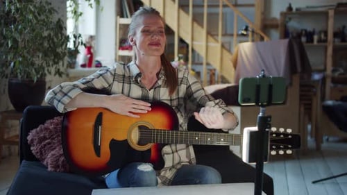 Woman Recording Guitar Lesson at Home
