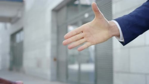 Business Partners Shaking Hands on Street. Handshake of Businessmen Outdoors