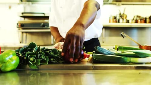Chef Prepares Fresh Vegetables in Commercial Kitchen