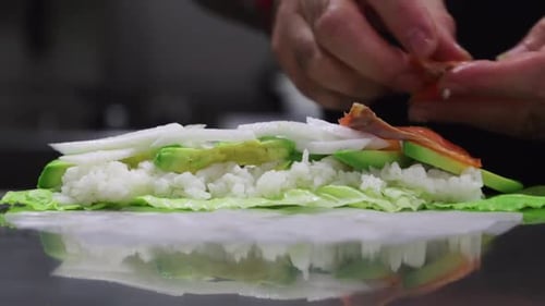 Crop cook preparing fresh rolls in cafe