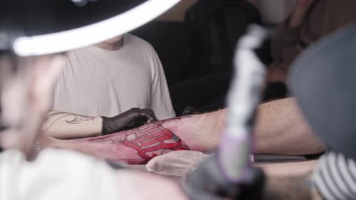 Young Man Working in the Tattoo Salon