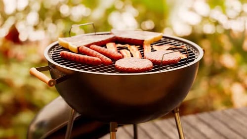 Grill at the garden. Traditional barbeque. Steaks, sausages, bacon and burgers.