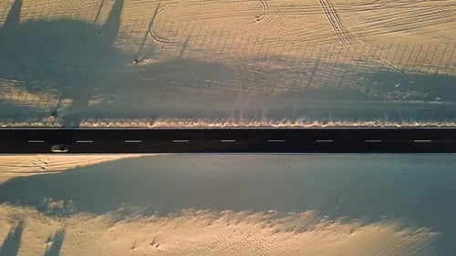 Long black asphalt road in the middle of the desert with nature and outdoors around - travel concept