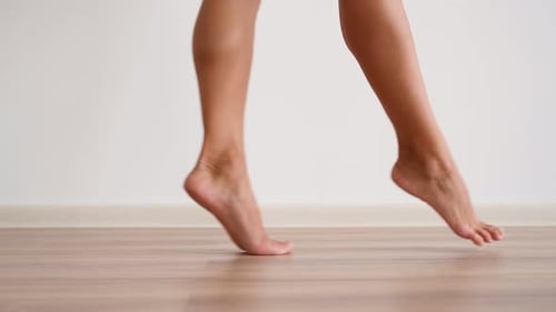 Slim Female Bare Feet Walking White Wall