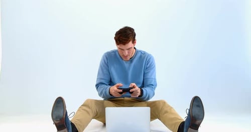 Man playing joystick game on laptop