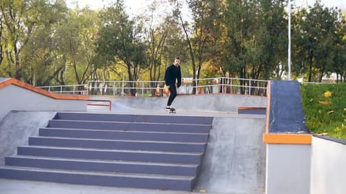 Hipster Skater Jumping Over the Stairs in Skate Park