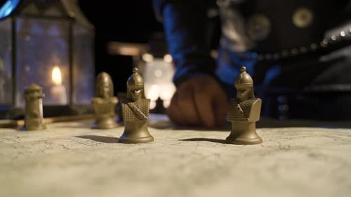 Hand Moves Figures Across Battle Map