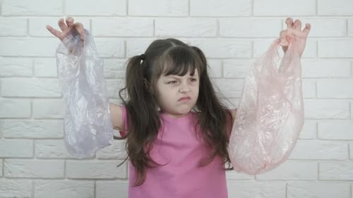 Child with plastic bag.