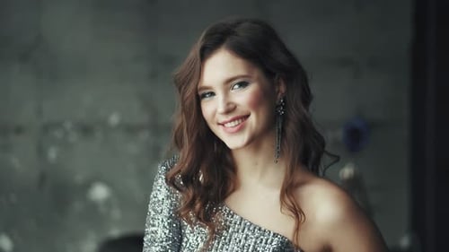 Glamorous Young Woman Smiling in Sequined Dress
