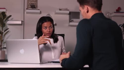 Woman Talking to Man During Hiring Interview at Table in Modern Office Spbi