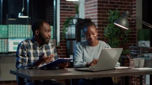 Financial Team of People Using Stock Market Statistics on Laptop