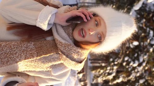 Young Woman Talking on Phone on Winter Day