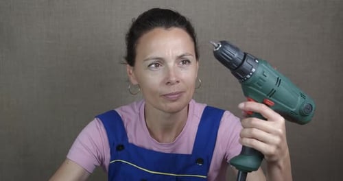 Woman Using Drill Machine