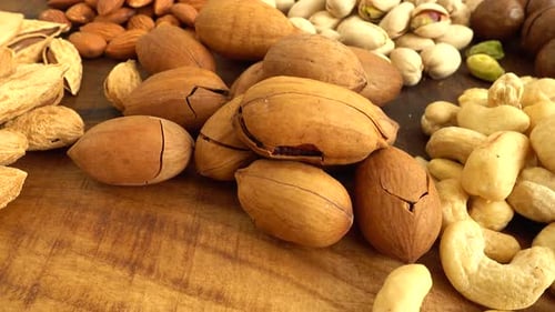 Assorted nuts on a wooden board.
