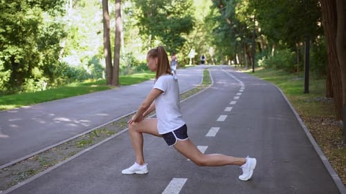 Woman Runner Stretching Legs Before Exercising Summer Park Morning