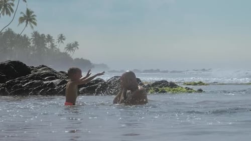 Family of Daddy and Son Has Fun in Ocean Bay Slow Motion