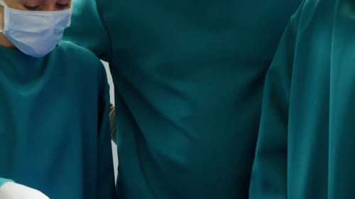 Medical Team Examines Patient on Operating Table